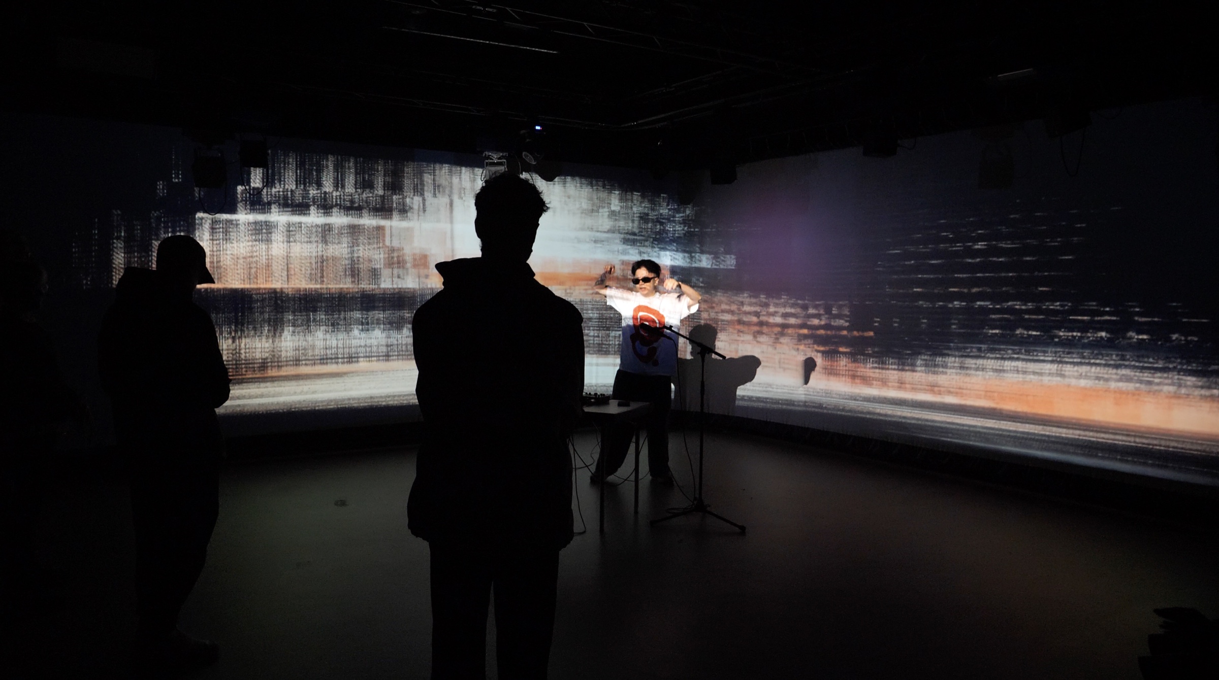 Audience and live performance surrounded by panoramic projections at STF