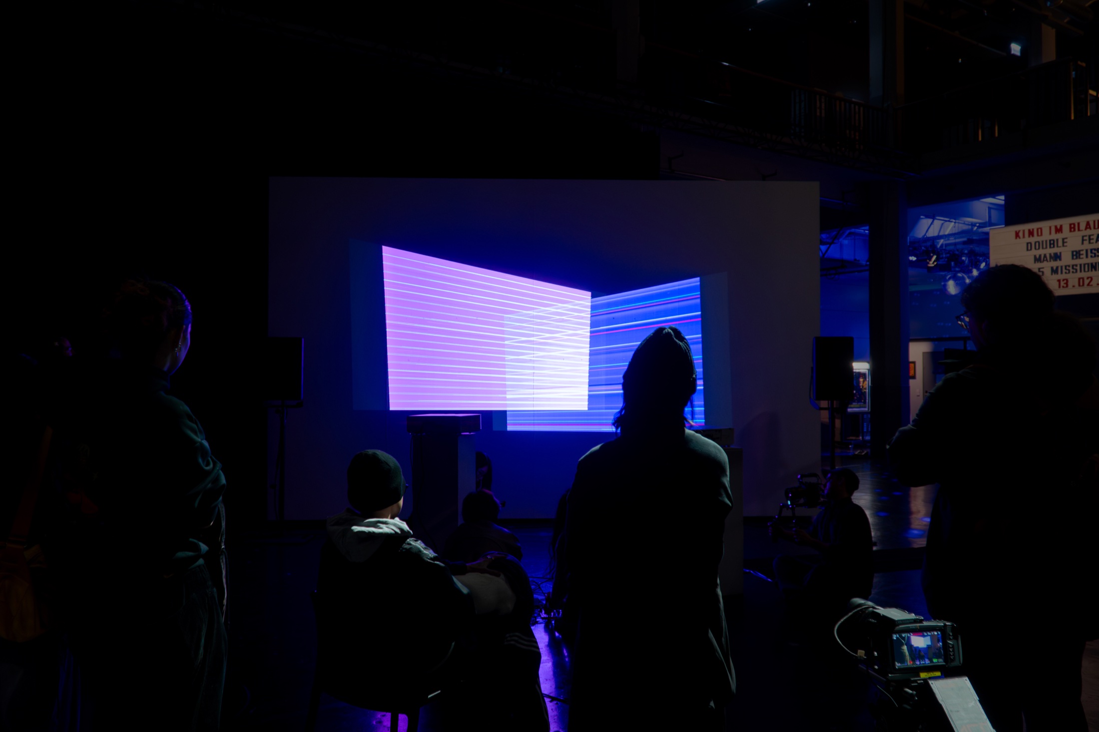 Audience watching the Overlap projection at HfG Atrium in Karlsruhe