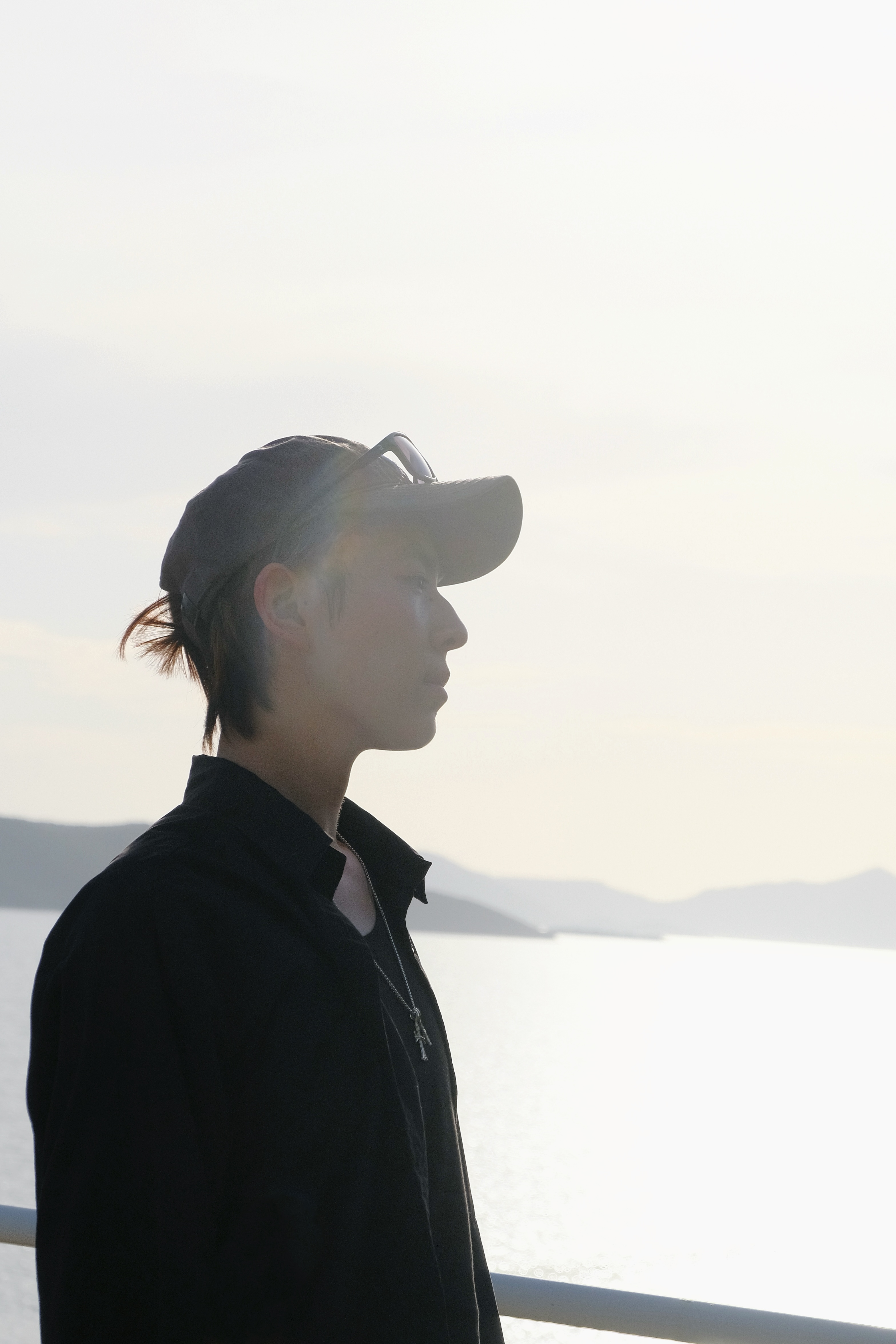 Xinyun Zhang in profile by the water